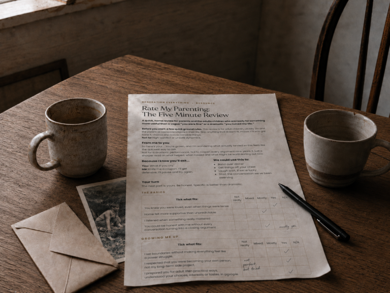 A wooden table with two mugs, a pen, an old family photo, an envelope and a printed parenting review form with handwritten notes.